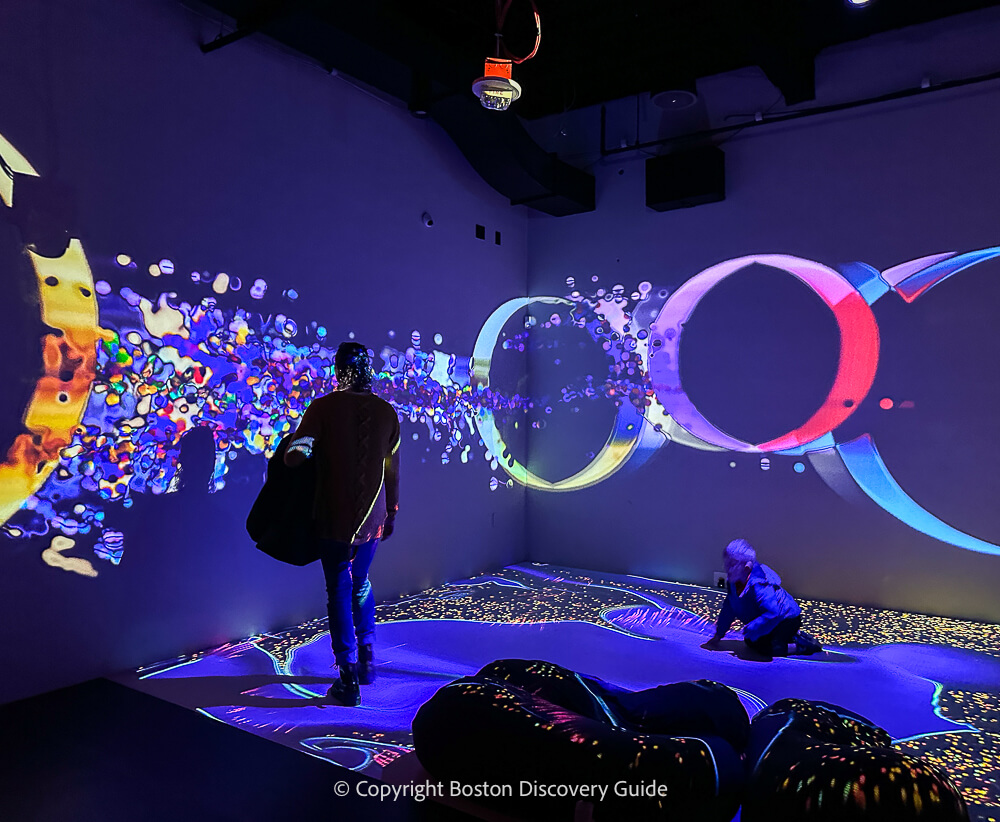 Young child making moving patterns in an interactive floor at WNDR Boston