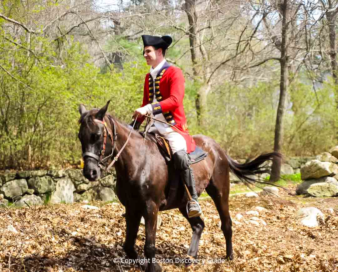 Reenactor portraying British officer on horseback during a battle reenactment near Hanscom Air Force Base in Lincoln